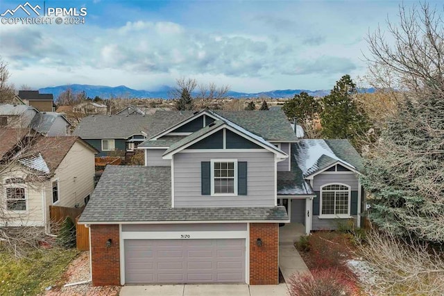 view of front of property featuring a mountain view and a garage