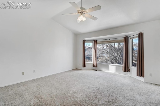 spare room with ceiling fan, carpet floors, and vaulted ceiling