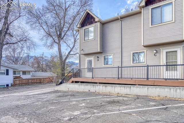 rear view of property featuring a wooden deck