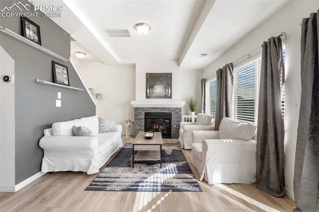 living room with a fireplace and light hardwood / wood-style flooring