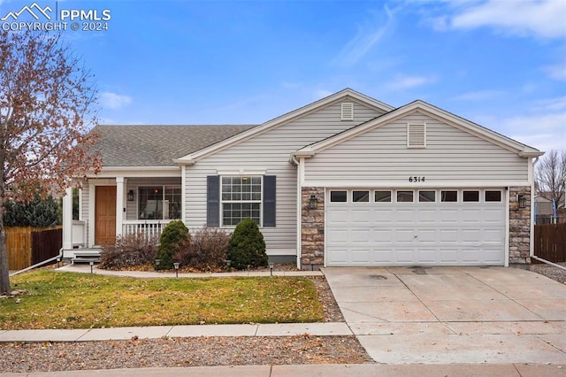 ranch-style house with a front yard, a porch, and a garage