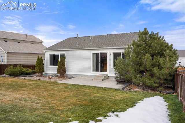 rear view of house featuring a lawn and a patio area