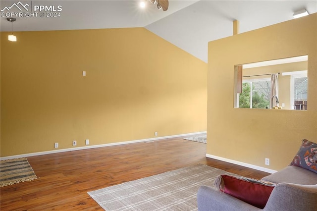 unfurnished room featuring hardwood / wood-style floors, ceiling fan, and high vaulted ceiling