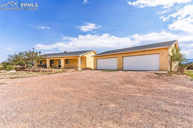 ranch-style house with a porch and a garage