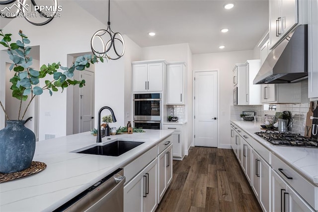 kitchen with white cabinetry, sink, an inviting chandelier, dark hardwood / wood-style floors, and ventilation hood