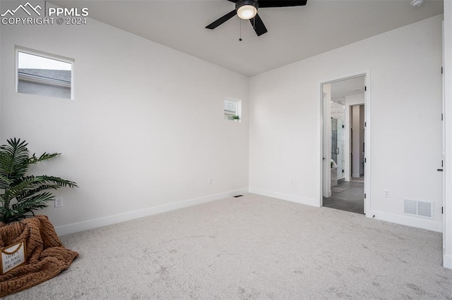 unfurnished room featuring ceiling fan and light colored carpet