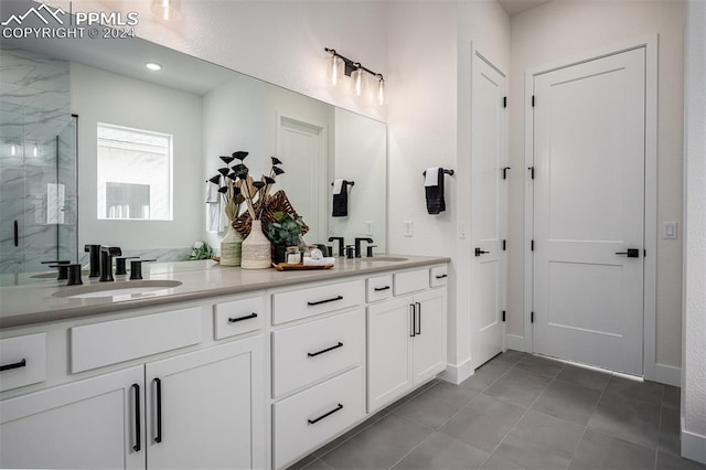 bathroom featuring vanity and a shower with door