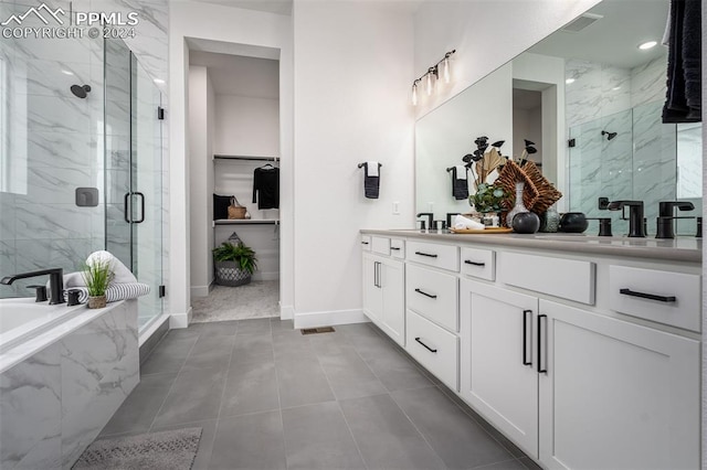 bathroom featuring tile patterned flooring, vanity, and plus walk in shower