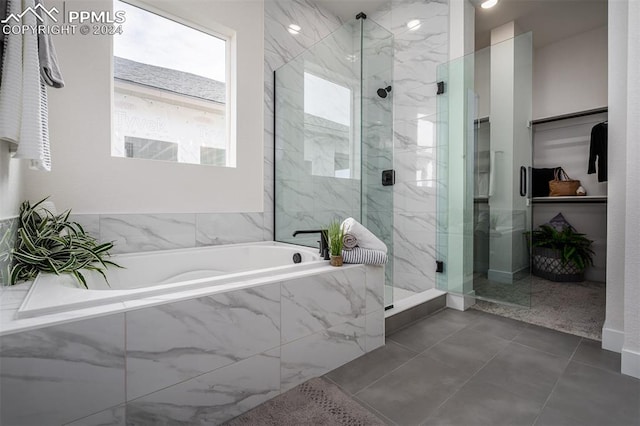 bathroom featuring tile patterned flooring and plus walk in shower