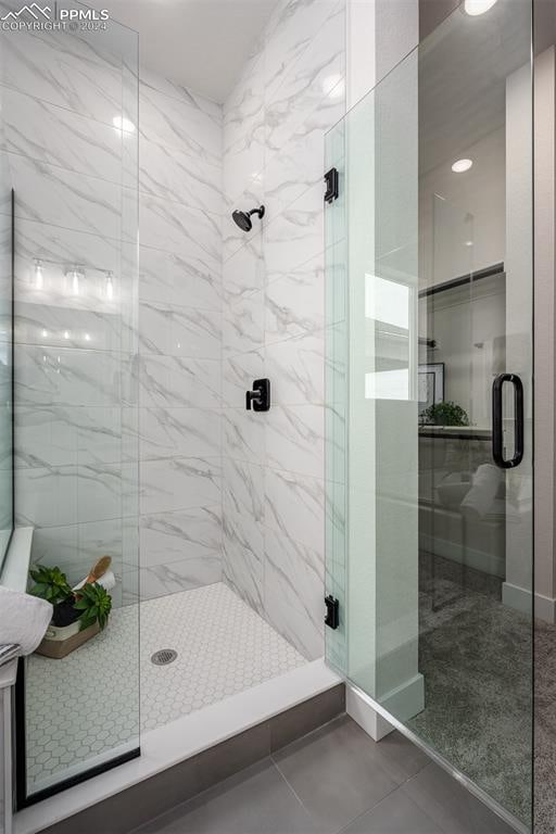 bathroom featuring tile patterned floors and an enclosed shower