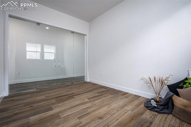 unfurnished room with dark hardwood / wood-style flooring