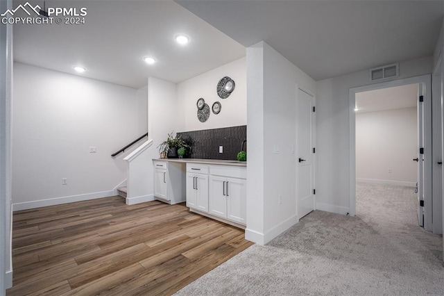 hall featuring light hardwood / wood-style flooring and sink