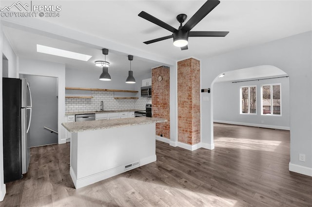 kitchen featuring stainless steel appliances, hanging light fixtures, dark wood-type flooring, and sink