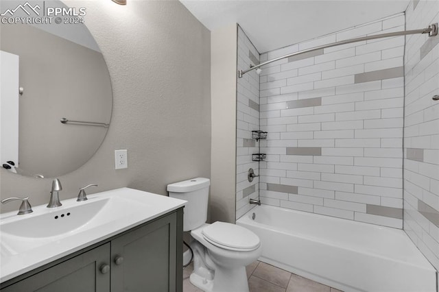 full bathroom featuring tile patterned flooring, vanity, toilet, and tiled shower / bath combo