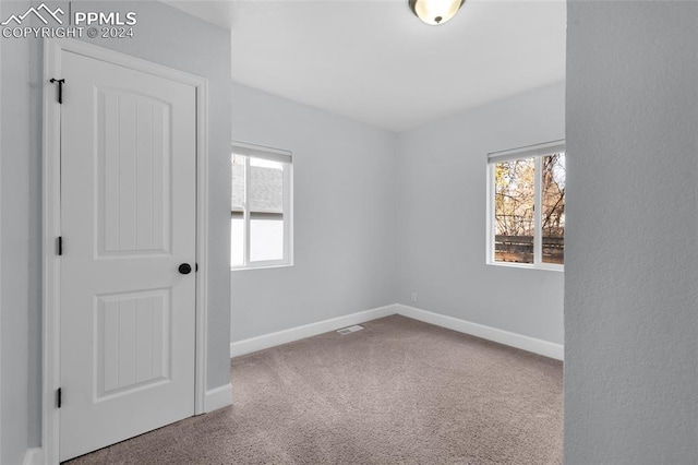 unfurnished room with carpet flooring