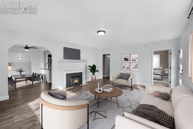 living room featuring hardwood / wood-style floors and ceiling fan