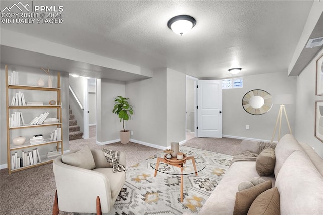 living room with carpet and a textured ceiling