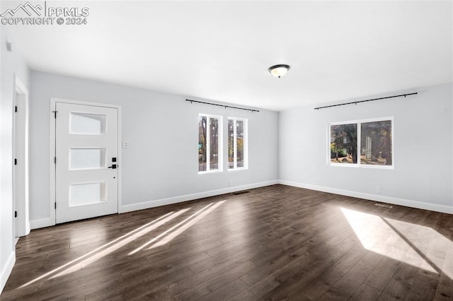 unfurnished room featuring dark wood-type flooring