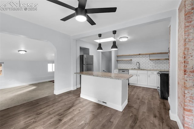 kitchen featuring stainless steel appliances, dark hardwood / wood-style flooring, decorative light fixtures, decorative backsplash, and white cabinets