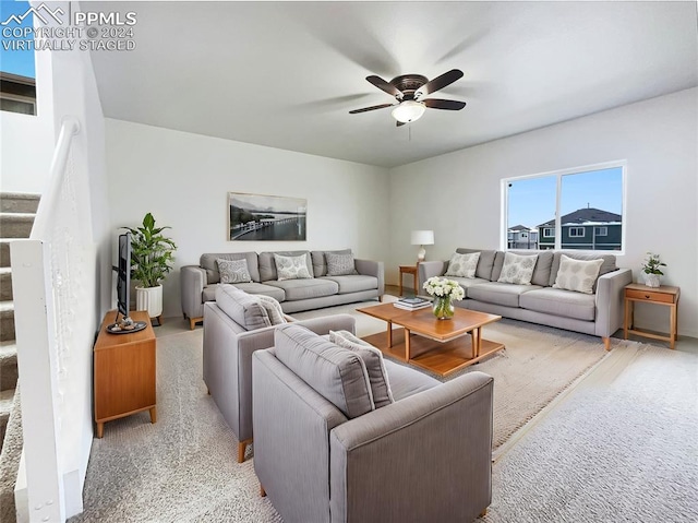 carpeted living room featuring ceiling fan