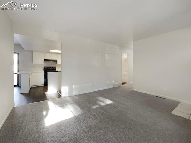 unfurnished living room with dark hardwood / wood-style floors