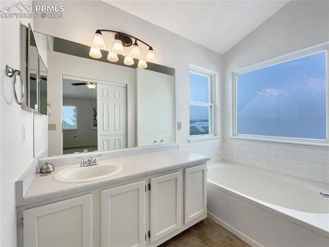 bathroom with a bath, vanity, ceiling fan, and lofted ceiling