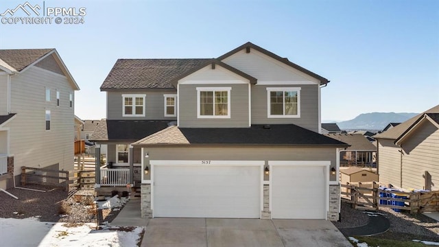 view of front facade with a mountain view and a garage