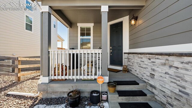 view of exterior entry with a porch