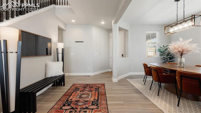 interior space with light hardwood / wood-style flooring and an inviting chandelier