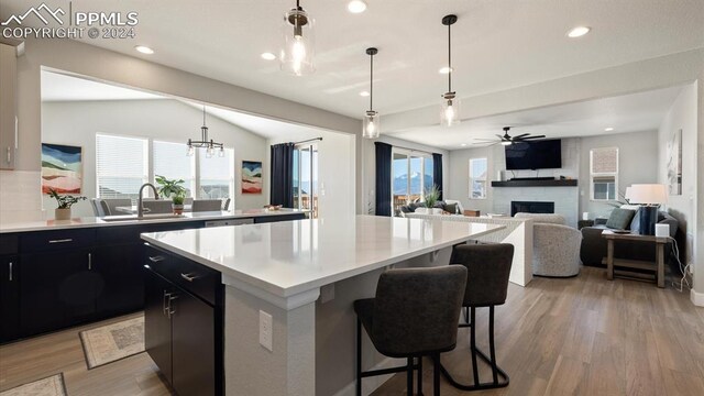 kitchen with a center island, a healthy amount of sunlight, and decorative light fixtures