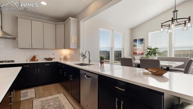 kitchen featuring sink, tasteful backsplash, decorative light fixtures, white cabinetry, and stainless steel appliances