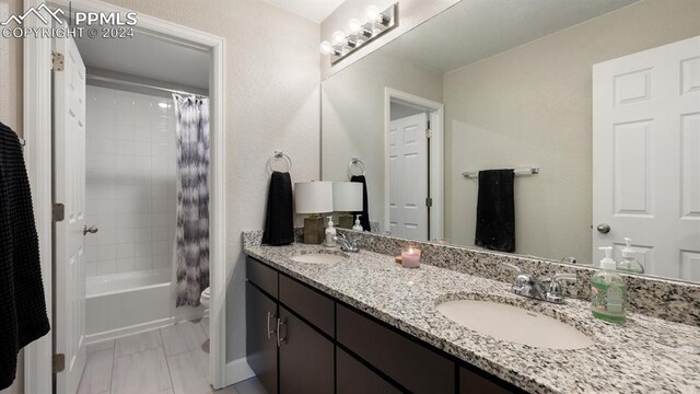 full bathroom featuring vanity, toilet, and shower / bath combo with shower curtain