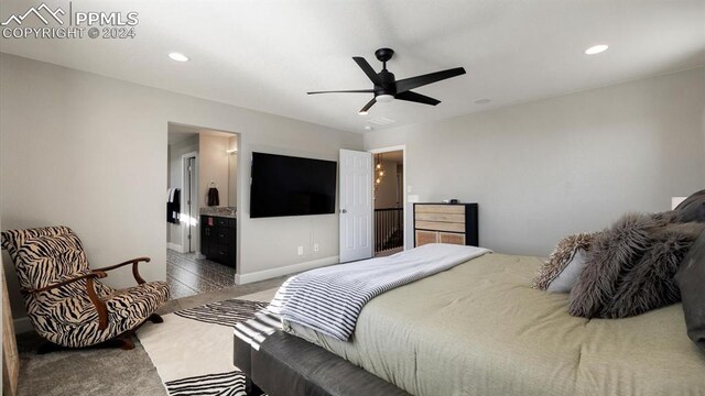 bedroom with carpet, connected bathroom, and ceiling fan