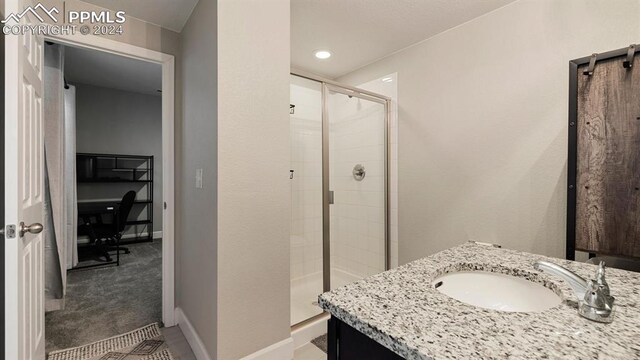 bathroom with vanity and a shower with shower door