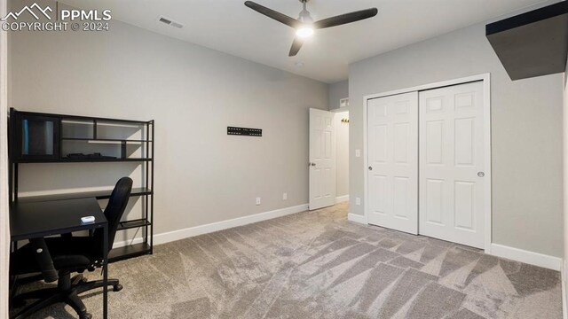 unfurnished office featuring carpet flooring and ceiling fan