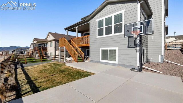 exterior space with a mountain view, a yard, and a patio