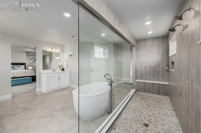 bathroom featuring plus walk in shower and vanity