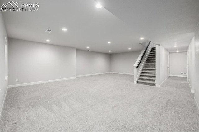 basement featuring light colored carpet