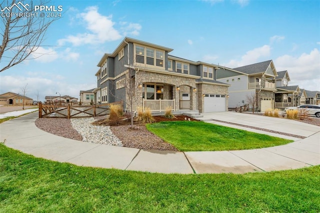 view of front of home featuring a front lawn, covered porch, and a garage