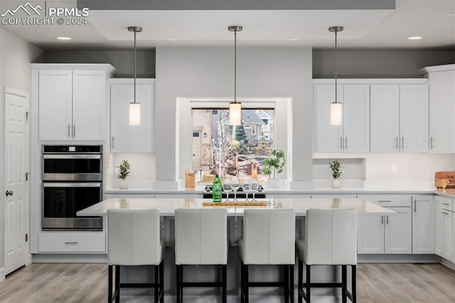 kitchen featuring a center island, white cabinets, and light hardwood / wood-style flooring