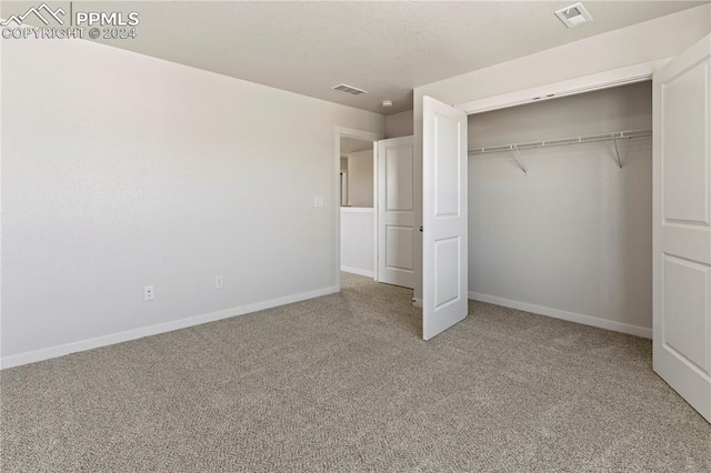 unfurnished bedroom with carpet floors and a closet