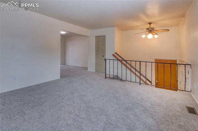 carpeted empty room with ceiling fan