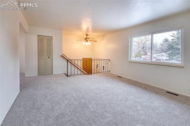 spare room with carpet flooring and ceiling fan