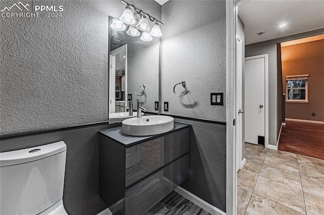 bathroom with tile patterned floors, vanity, and toilet