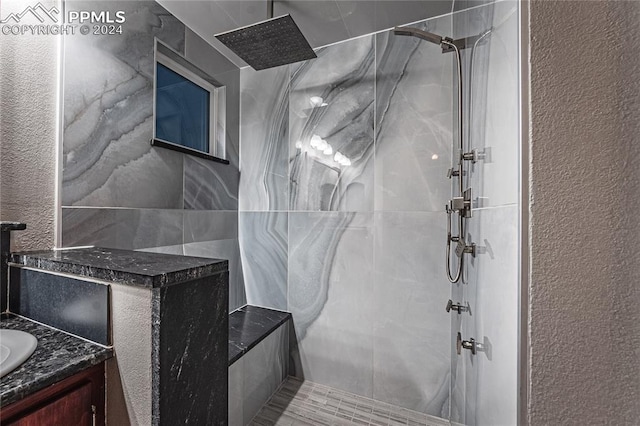 bathroom featuring vanity and a tile shower