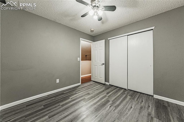 unfurnished bedroom featuring hardwood / wood-style floors, ceiling fan, a textured ceiling, and a closet