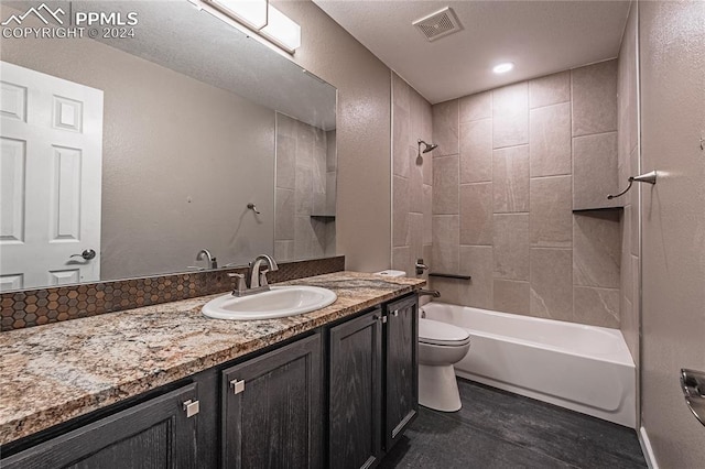 full bathroom featuring vanity, toilet, and tiled shower / bath combo