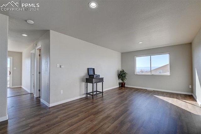 spare room with dark hardwood / wood-style floors