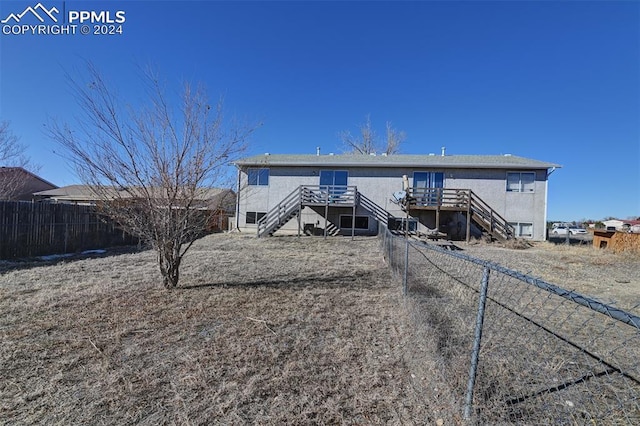 rear view of property featuring a wooden deck