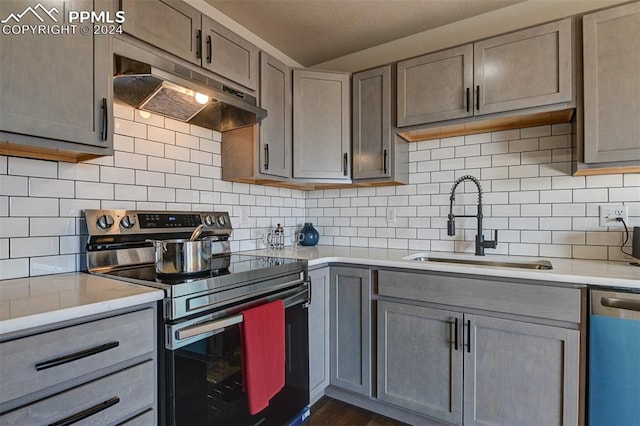 kitchen featuring backsplash, sink, and appliances with stainless steel finishes